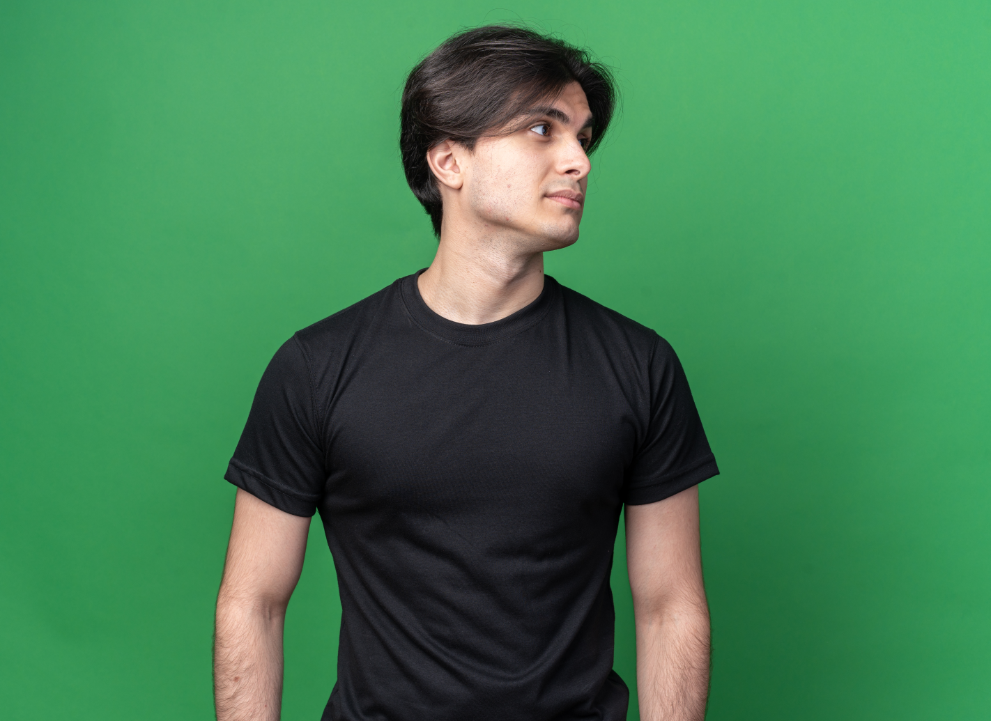 Man wearing a black t-shirt against a green background