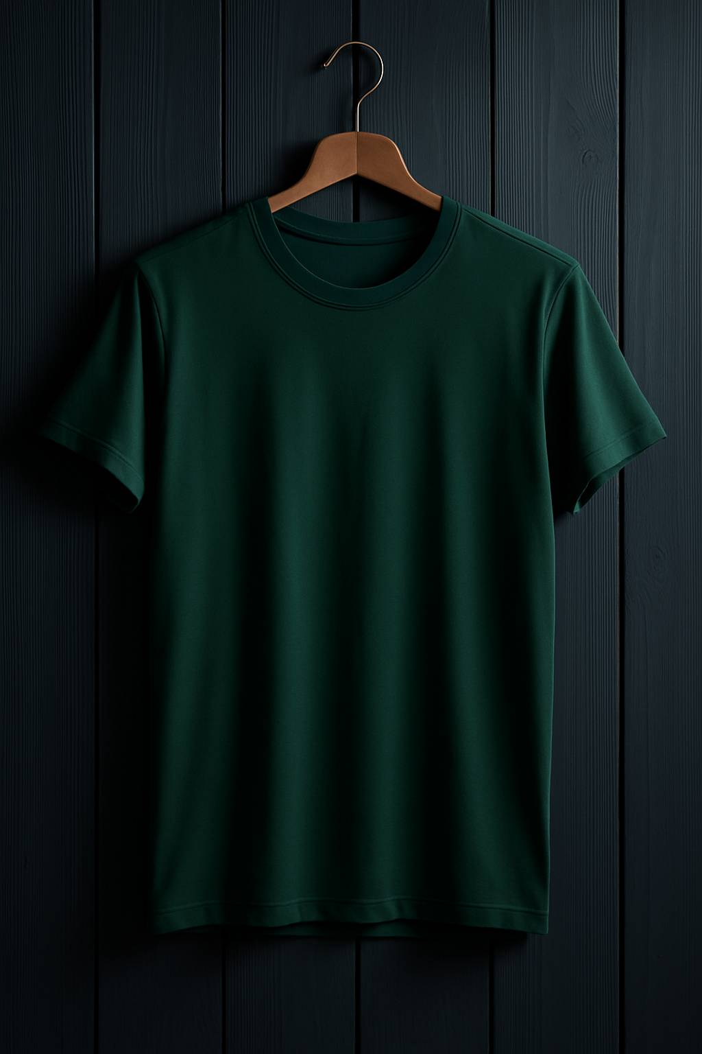 Green t-shirt on a wooden hanger against a dark wooden panel background