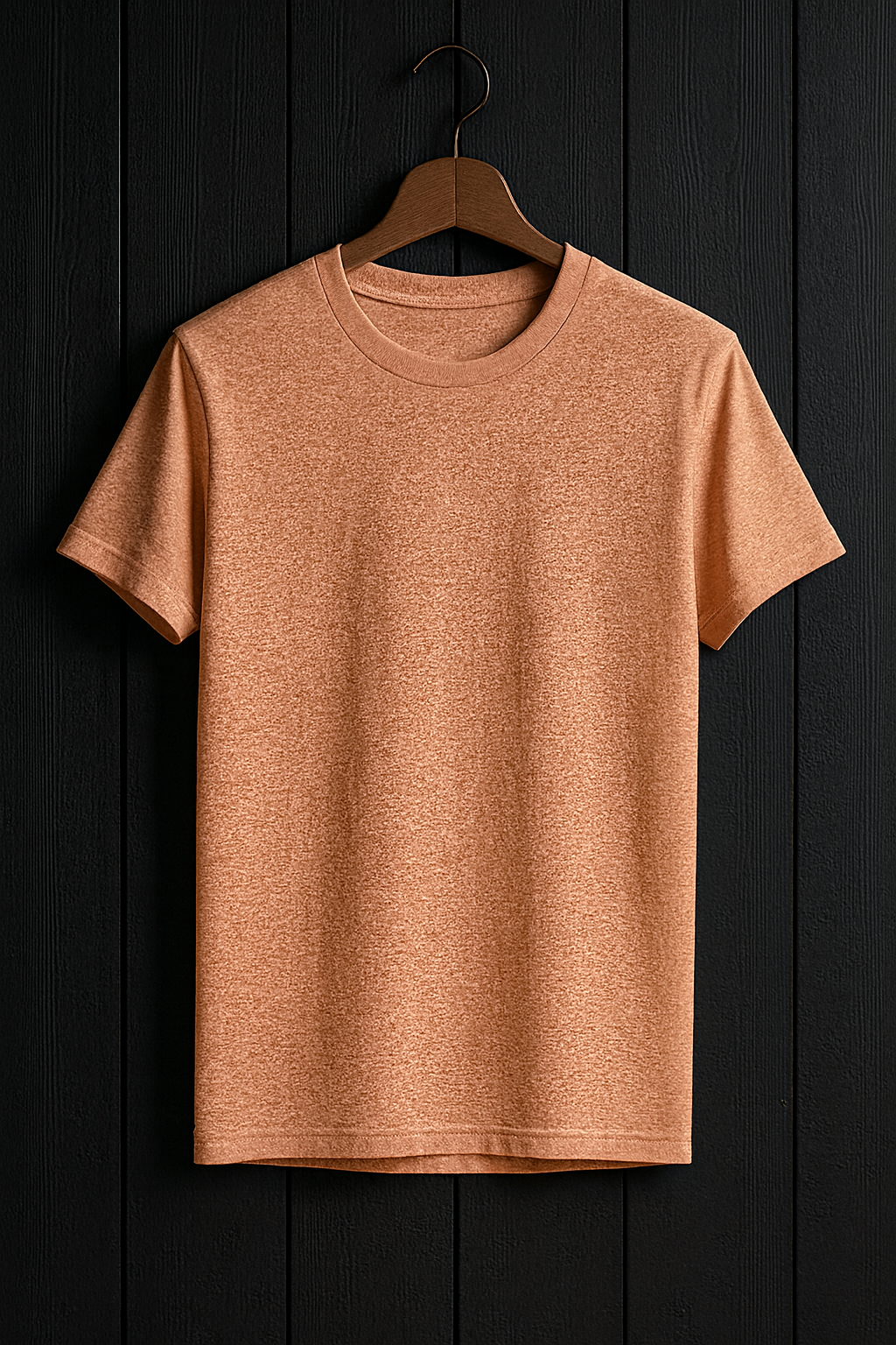 Peach t-shirt on a wooden hanger against a black wooden panel background